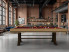 billard ATELIER gamme EXCELLENCE en chene nature brosse avec pieds rouille et tapis rouge dans un loft moderne