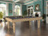 billard Castel en chêne nature x2 avec tapis gris ardoise, un salon de style haussmannien avec miroir doré, cheminée blanche