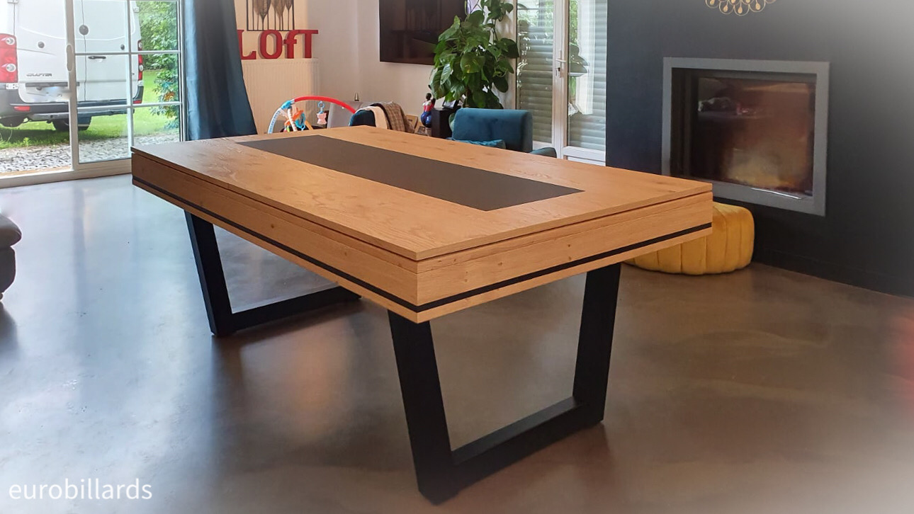 Élancé vers le haut sur ses deux pieds métalliques noir ce billard Harmony V d'Eurobillards en taille 210 illustre joliment le style industriel avec son mélange bois de chêne brossé nat x2, la plaque de déco noire centrée sur le plateau ST et son petit liseré noir incrusté dans le cadre en bois.